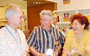 Bela Bollobas, Sergei Gelfand and Carol-Ann Blackwood in the AMS Book exhibit